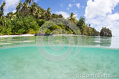 Kayaker and Remote Beach in Raja Ampat Editorial Stock Photo