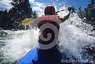 Kayaker Paddling Through Rapids Stock Photo