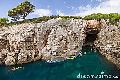 Kayakers at a sea cave at the Lokrum Island in Croatia Stock Photo