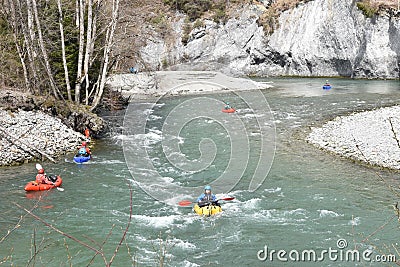 Kayakers on whitewater in Rhine Gorge Ruinaulta in Switzerland. They are manoeuvring with oars to keep balance. Editorial Stock Photo