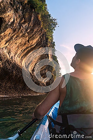 Kayaking around hight amazing Limestone Rocks at Railey Beach in Krabi, Thailand. Sunset Time Stock Photo