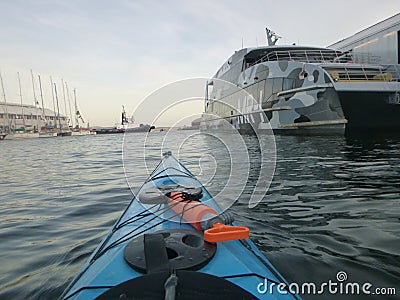 Kayaking around the yachts Stock Photo