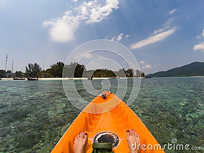 kayaking in crystal clear tropical waters - kayak heading to isolated beach in Ko Tarutao national park Stock Photo