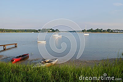 Kayaks and boats in the calm waters of Buzzards Bay, Onset, Massachusetts, USA. Stock Photo