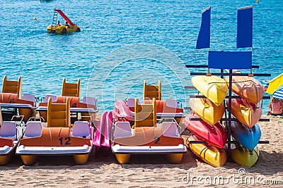 Kayaks and catamarans on the sea in Lloret de mar, Costa Brava, Spain. Leisure rest on sea vacation Stock Photo