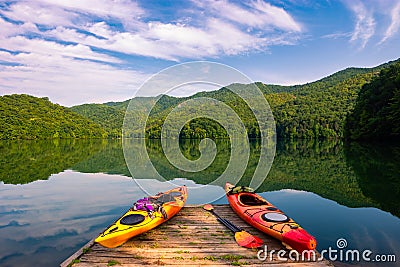 Kayaks docked on mountain lake Stock Photo