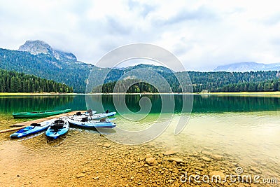 Kayaks docked on the shore of Black Lake. Mountain landscape, Durmitor National Park, Zabljak, Montenegro. Stock Photo