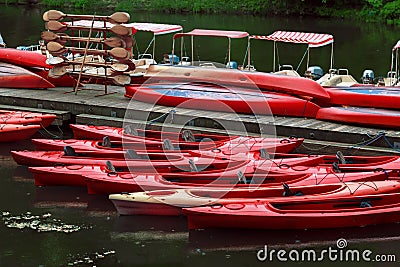 Kayaks rent point. The red boats on pier Stock Photo