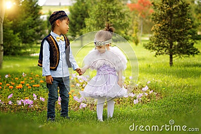 Kazakh little boy and girl together playing Stock Photo