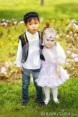 Kazakh little boy and girl together playing Stock Photo