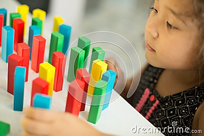 Kazakh pretty little girl playing in kids development center Stock Photo