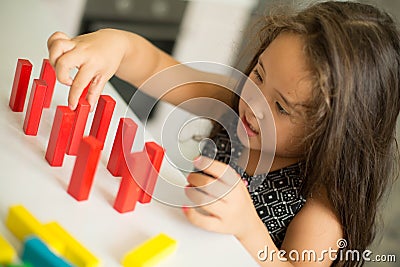 Kazakh pretty little girl playing in kids development center Stock Photo