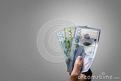 Kazakh Tenge banknotes held by a hand Stock Photo