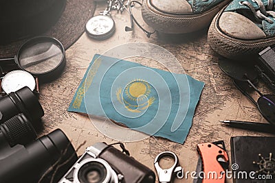 Kazakhstan Flag Between Traveler`s Accessories on Old Vintage Map. Tourist Destination Concept Stock Photo