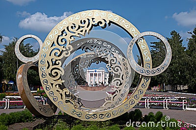 Kazakhstan, Qostanai, August 1, 2022. Sculpture - Rings with ornament in the central park overlooking the university in honor of Editorial Stock Photo