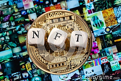 The word NFT non-fungible token is laid out of cubes with letters and golden cryptocoin on background Beeple digital art EVERYDA Editorial Stock Photo