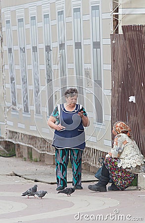 KAZAN, RUSSIA - MAY 17, 2018: Bauman street - Mature female beggar asks for alms on the street Editorial Stock Photo