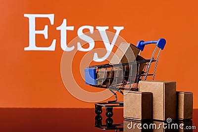 Shopping cart with parcels on the background of the Etsy logo Editorial Stock Photo