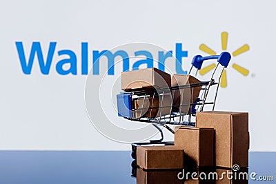 Walmart is an American multinational retail corporation. Shopping cart with parcels on the background of the Walmart logo Editorial Stock Photo