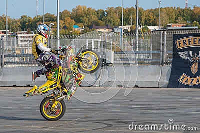 A biker rides on the back wheel of a bike Editorial Stock Photo