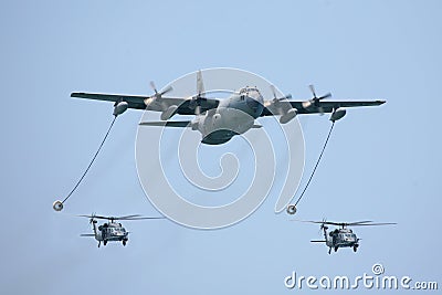 KC-130 tactical tanker with two helicopters Stock Photo