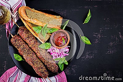 Kebab adana, lamb and beef and toasts with pesto sauce. Stock Photo