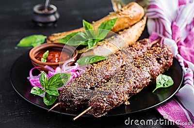 Kebab adana, lamb and beef and toasts with pesto sauceKebab adana, lamb and beef and toasts Stock Photo