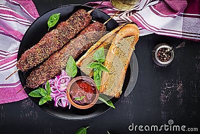 Kebab adana, lamb and beef and toasts with pesto sauce. Stock Photo