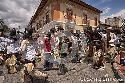 Kechwa men running on the street in Ecuador Editorial Stock Photo