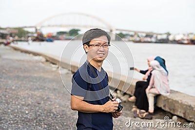 Chinese man with camera Editorial Stock Photo