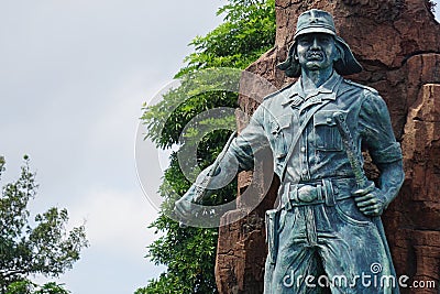 Kediri-Syu PETA monument in Kediri. The statue holding sword and keris Javanese weapon Editorial Stock Photo