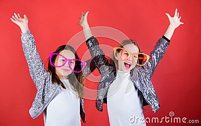 Keep celebrating. Cool party girls wearing fancy glasses. Small kids in party goggles having fun. Party girls. Happy Stock Photo