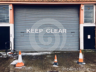 Keep clear sign on garage metal shutter door Stock Photo