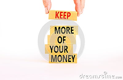 Keep more of your money symbol. Concept words Keep more of your money on wooden block. Beautiful white table white background. Stock Photo