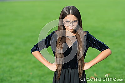 Keep out. Nasty look of girl child. Angry girl keep hands on hips outdoors. Disobedient kid. Having negative emotional Stock Photo