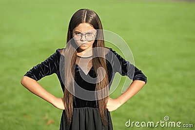 Keep out. Nasty look of girl child. Angry girl keep hands on hips outdoors. Disobedient kid. Having negative emotional Stock Photo