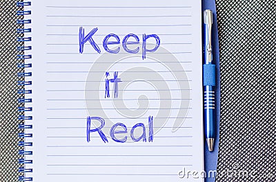 Keep it real write on notebook Stock Photo