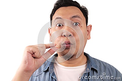 Keep secret, man zipping locking mouth shut gesture, mute and silence Stock Photo