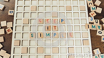 Keep it simple. Good advice concept. Colourful wooden square letters creating strong message. Stock Photo