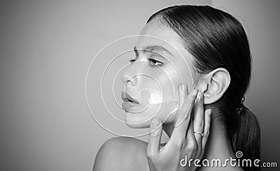 Keep skin hydrated regularly moisturizing cream. Taking good care of her skin. Beautiful woman spreading cream on her Stock Photo