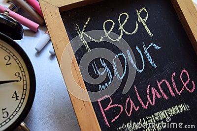 Keep your balance on phrase colorful handwritten on chalkboard Stock Photo