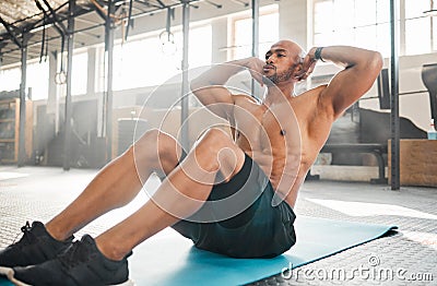 Keep your core engaged. a young man completing crunches. Stock Photo