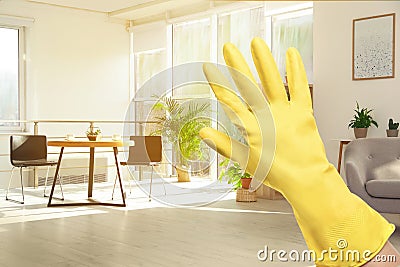 Keep your home virus-free. Woman in glove at sunlit room Stock Photo
