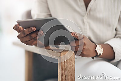 Keeping connected with important people. a businesswoman using her digital tablet at work. Stock Photo