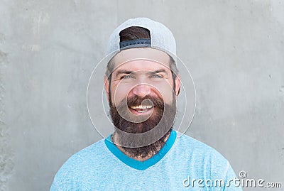 Keeping hair healthy. Happy hipster with shaped beard and styled hair wearing baseball cap. Bearded man smiling with Stock Photo