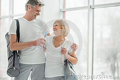 Keeping a healthy mind and body.Beautiful couple before sport training standing and talking with each other Stock Photo