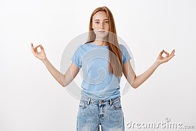 Keeping mind healthy and calm. Relaxed energized good-looking female sportswoman with freckles in casual clothes Stock Photo