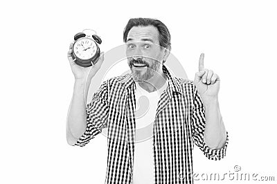 Keeping track of time. Mature timekeeper with analog clock pointing finger up. Mature man holding alarm clock. Bearded Stock Photo