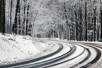 Kekesteto, Hungary - Winding winter road at the mountains of Matra near Kekesteto. Curved asphalt road with snowy trees Stock Photo