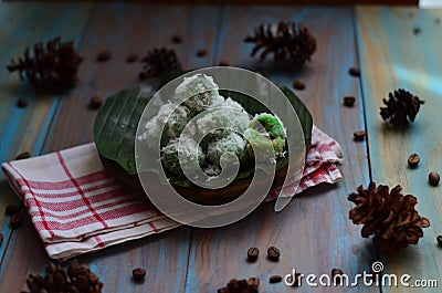 kelepon or klepon made from glutinous rice flour and filled with brownn sugar covered with grated coconut. indonesian food. Stock Photo
